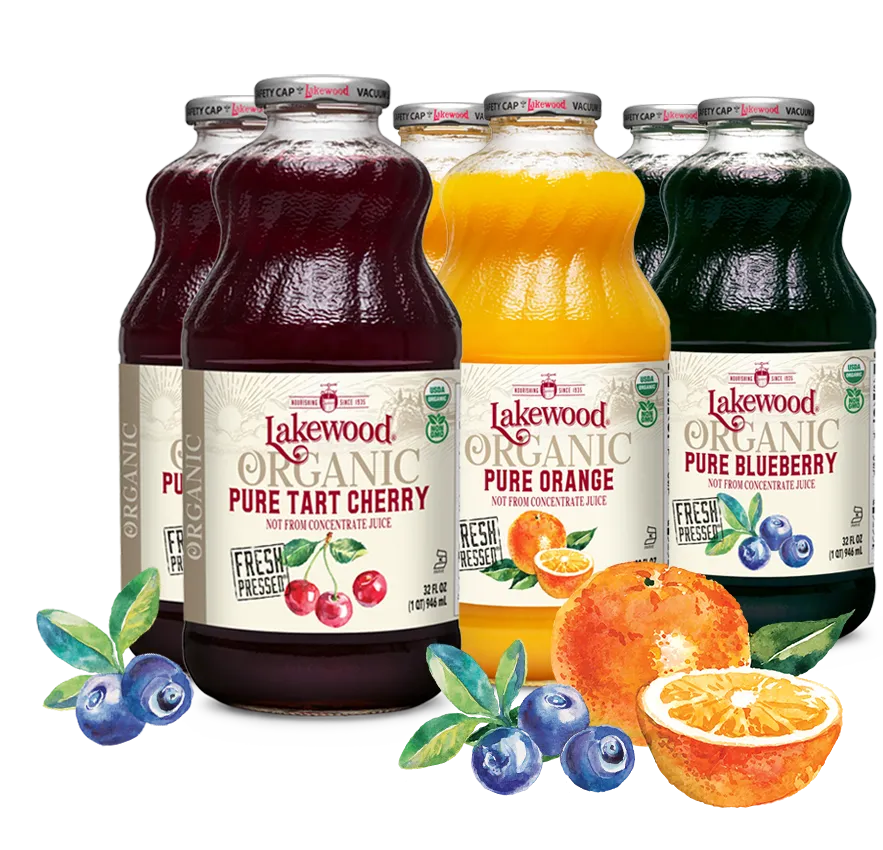 Bottles of Lakewood Organic juice with cherry, orange, and blueberry flavors on a white background.