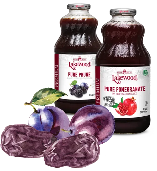 Two bottles of Lakewood Pure Prune and Pure Pomegranate juice with prunes and pomegranates on a white background.
